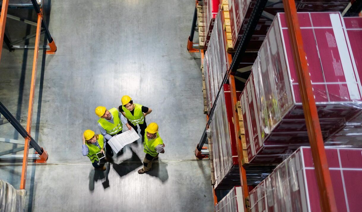 warehouse manager and workers consult plans betwee mwzjbnv.jpg