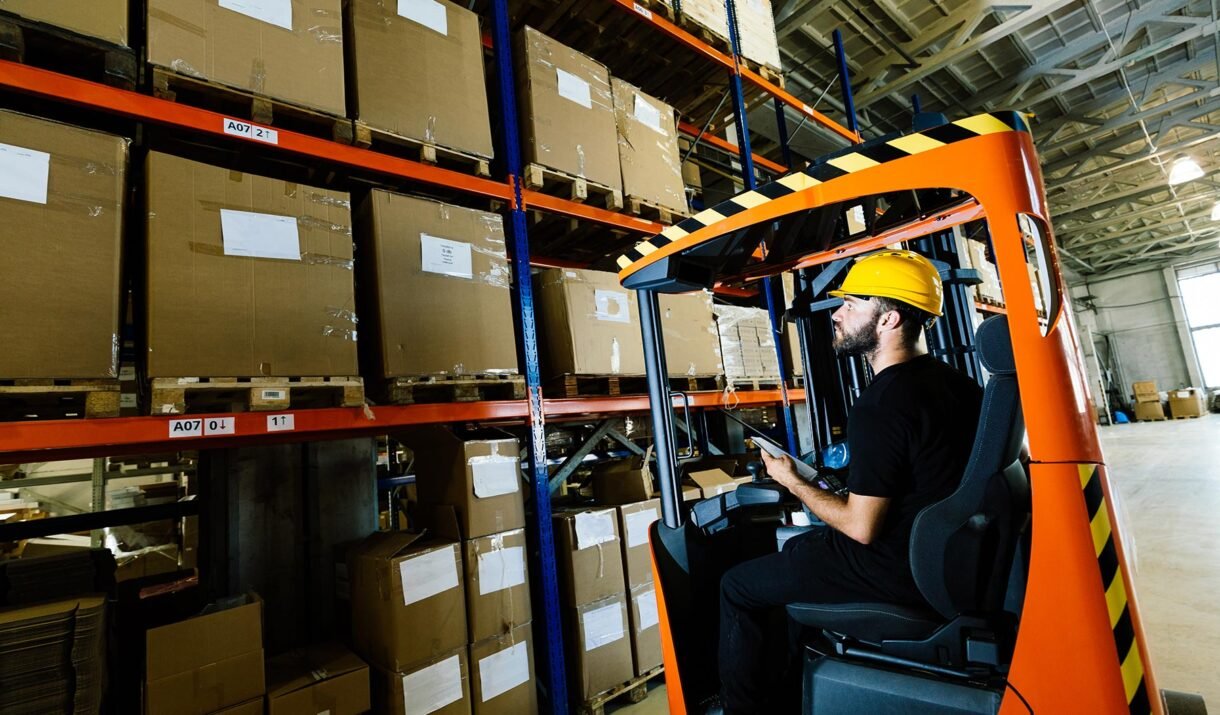 warehouse worker doing logistics work with forklif gpv9kcy.jpg