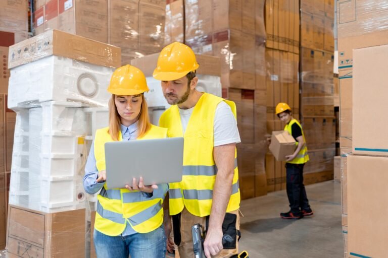 warehouse workers consult delivery plans using lap 3e6pbvc 768x512 1.jpg
